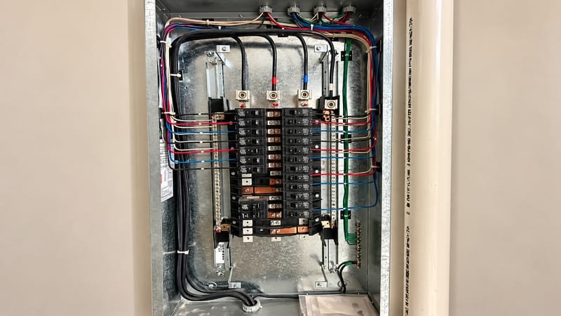 Neatly wired electrical breaker panel interior with labelled circuits